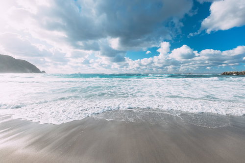 東京の離島・神津島の波打ち際に広がる白い砂浜と青い海