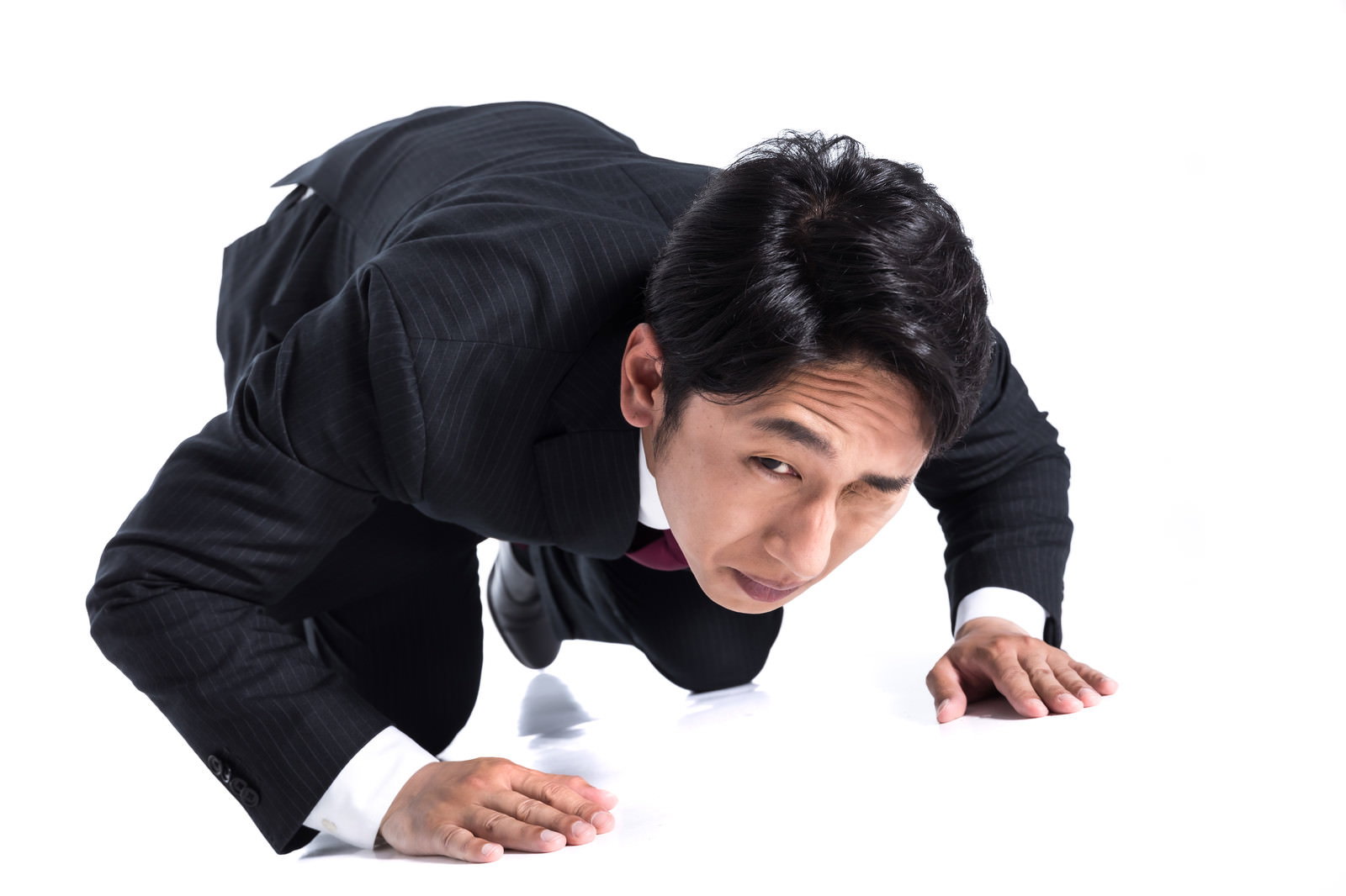 黒いスーツを着た男性が土下座で謝罪している様子［モデル：大川竜弥］