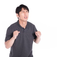 無念の表情で両手を握り締めている男性の感情表現の写真