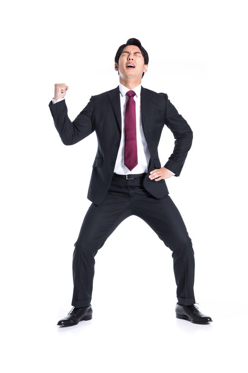 集中力が切れた会社員の力強いガッツポーズ