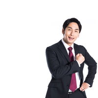 ご依頼はぜひ当社に！気合注入ポーズの男性ビジネスマンの写真