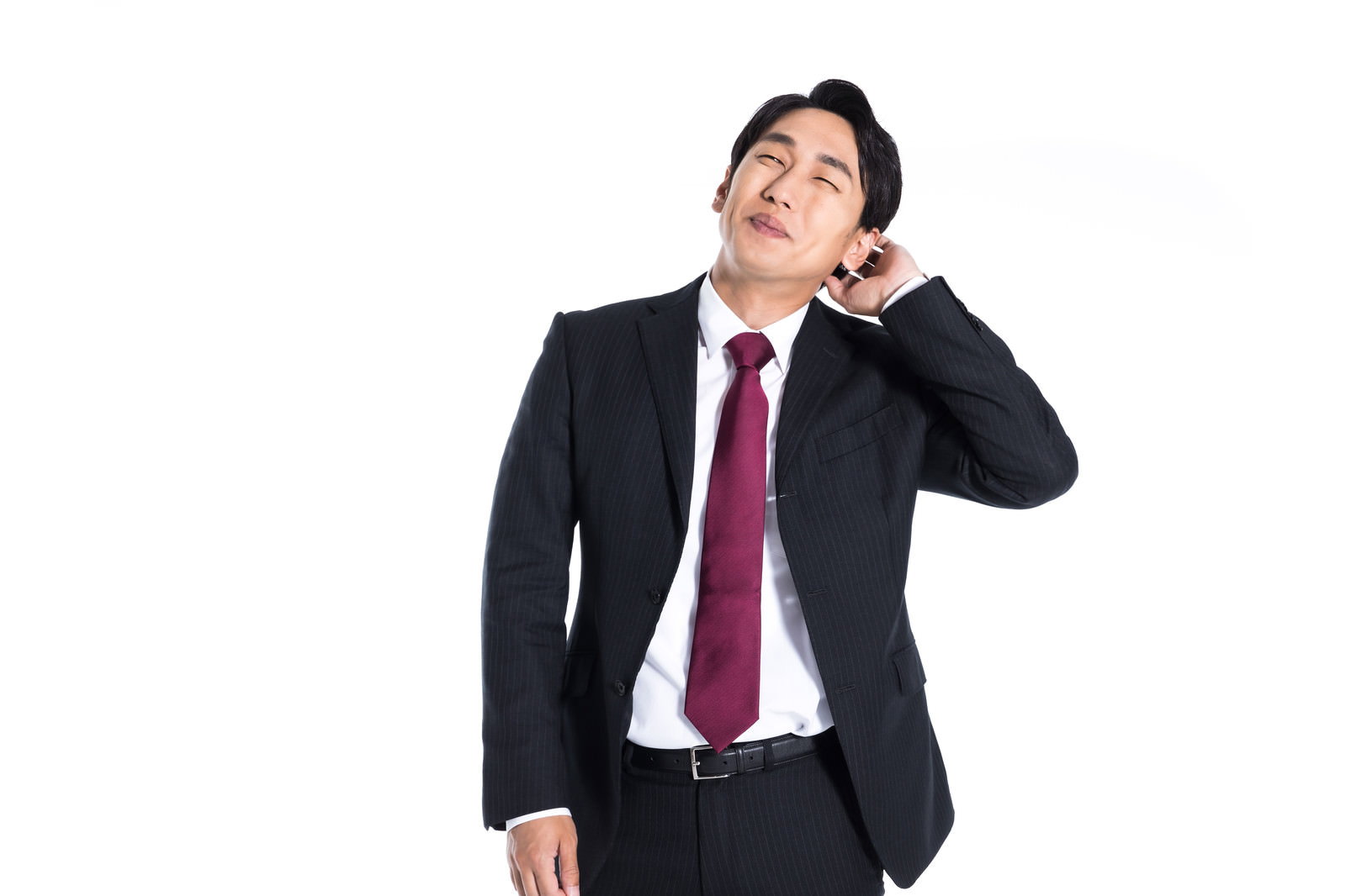 上司にほめられて照れている紺色のスーツを着た会社員［モデル：大川竜弥］