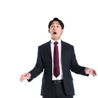 予想外の朗報に両腕を広げて驚く会社員の写真