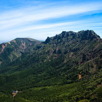 阿弥陀山頂から望む緑の山々と青空の眺望の写真
