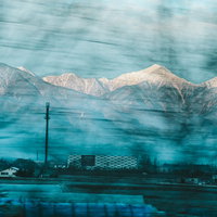 車窓から見える冬の常念岳、北アルプスの雪化粧の写真