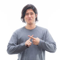 ダメダメすぎて梅干し顔、グレーのニットで指差す男性の写真