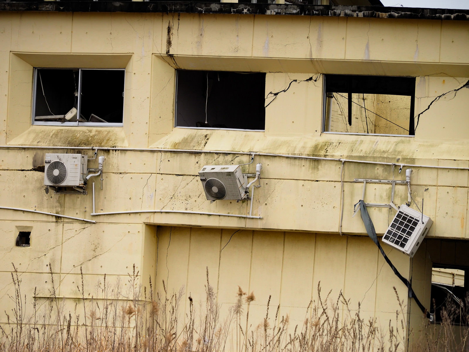 Exterior walls and air conditioning outdoor units of the Rikuzentakata Youth Hostel damaged by the tsunami