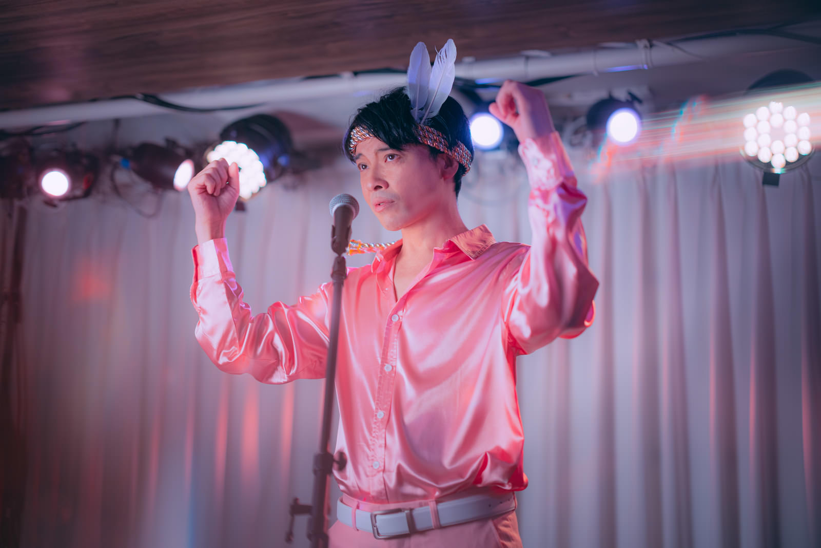 ステージでアイドルポーズを取る社長の男性［モデル：金子周平］