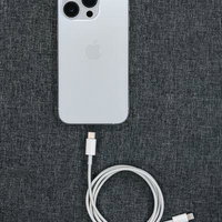 白いiPhoneとライトニングケーブルの充電セットの写真