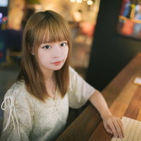 カフェで待ち合わせしながらデスクワークする女性の写真