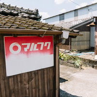 田舎の古い民家に残るマルフクのサラ金看板の写真