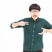 ぶちうまいポーズをする眼鏡の男性がラーメンを食べておいしい表現の写真