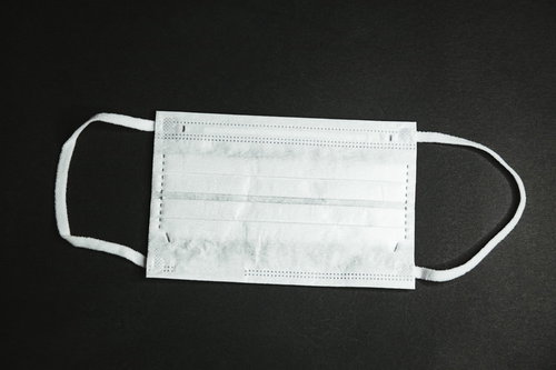 市販品の白い不織布マスクを入手した様子、耳かけゴムひも付き
