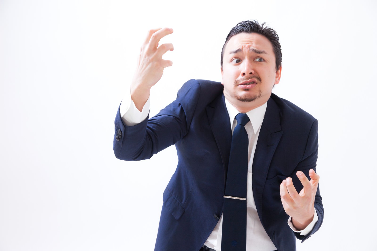 紺色のスーツを着た男性が、両手を広げて失敗を表現する［モデル：Max_Ezaki］