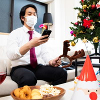 スマホを見ながらシングルベルを楽しむ男性の写真