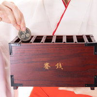 リップルをお賽銭箱に入れる巫女の仮想通貨参拝の写真