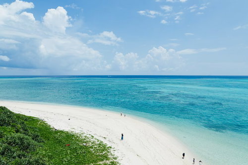 エメラルドグリーンの海と白い砂浜の宮古島観光客