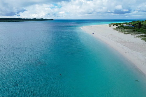白砂ビーチと青いラグーンの空撮