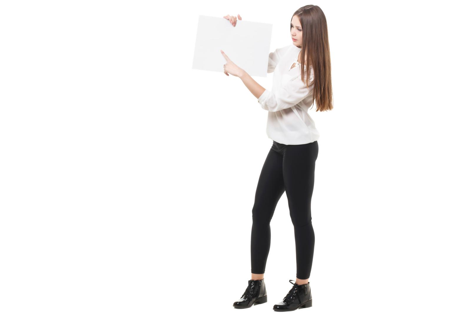 A long-haired woman in a white shirt holding a white box with both hands and gazing at it.