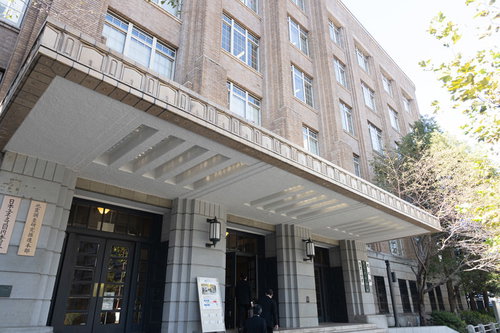 文部科学省の正面出入口、白い建物のガラス張りエントランス