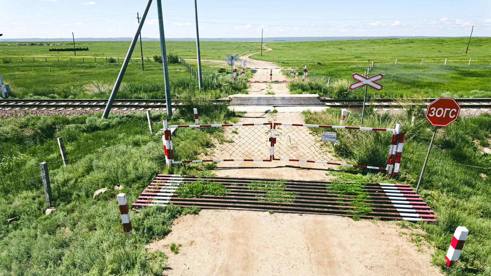 Railroad crossing with barrier gates on the Mongolian steppe