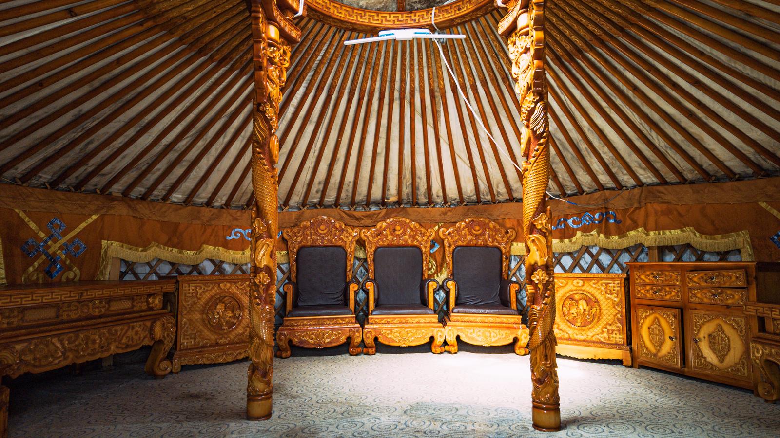 モンゴルの伝統ゲル内部。装飾的な木製柱と彫刻入りの座席