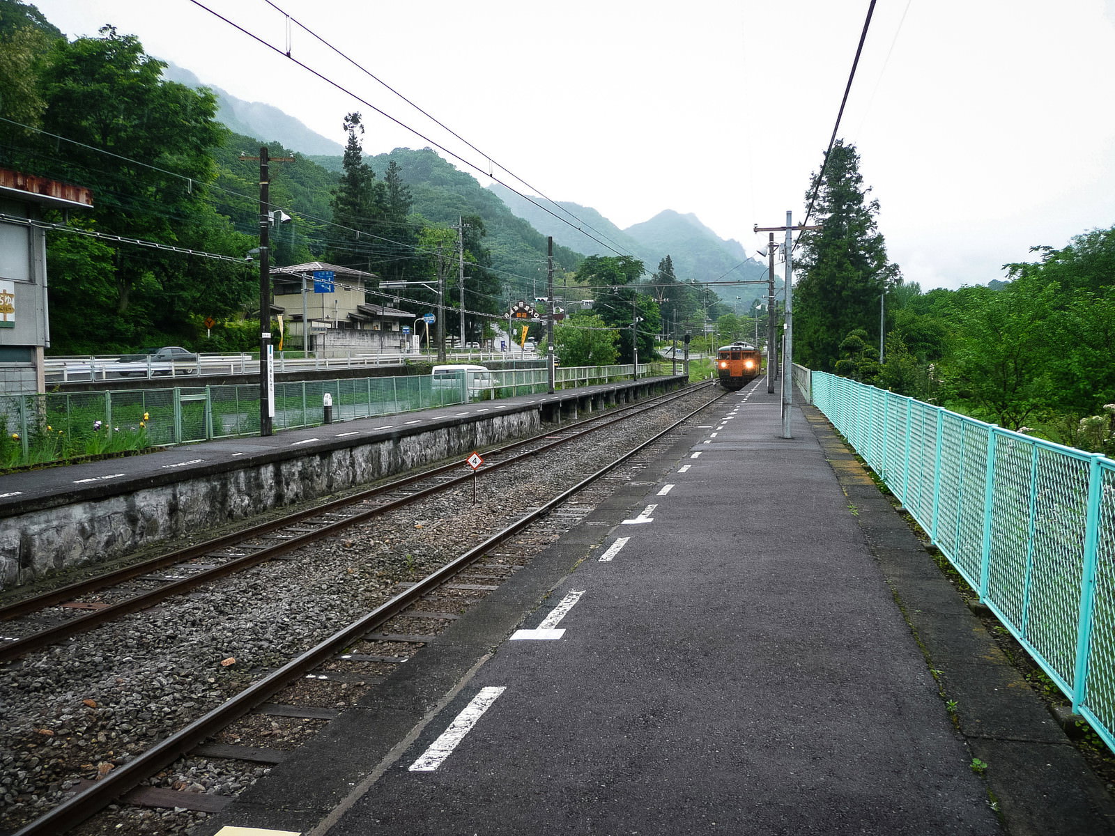 緑の山々に囲まれた旧川原湯温泉駅のホームとJR吾妻線の線路
