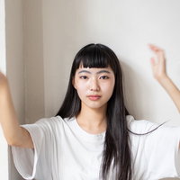両手を上げて手振りをする女性のジェスチャーの写真