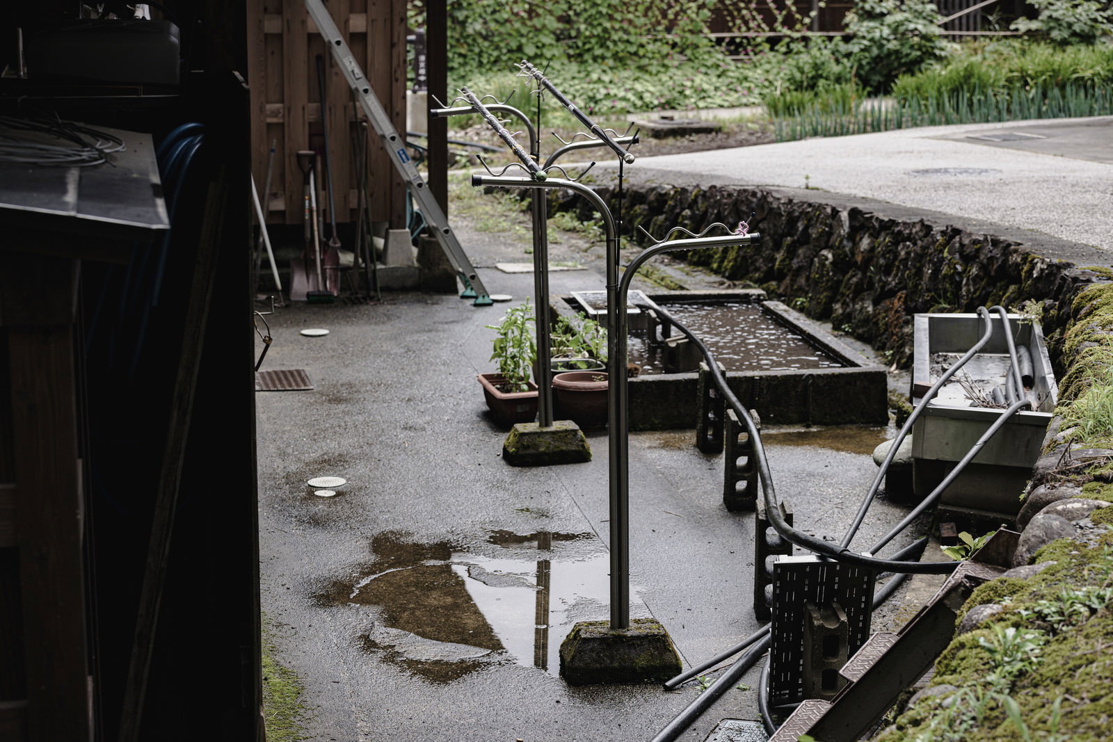 五箇山の合掌造り集落で雨に濡れた物干し台と物干し竿
