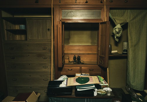 残置物が散乱する空き家の室内と仏壇