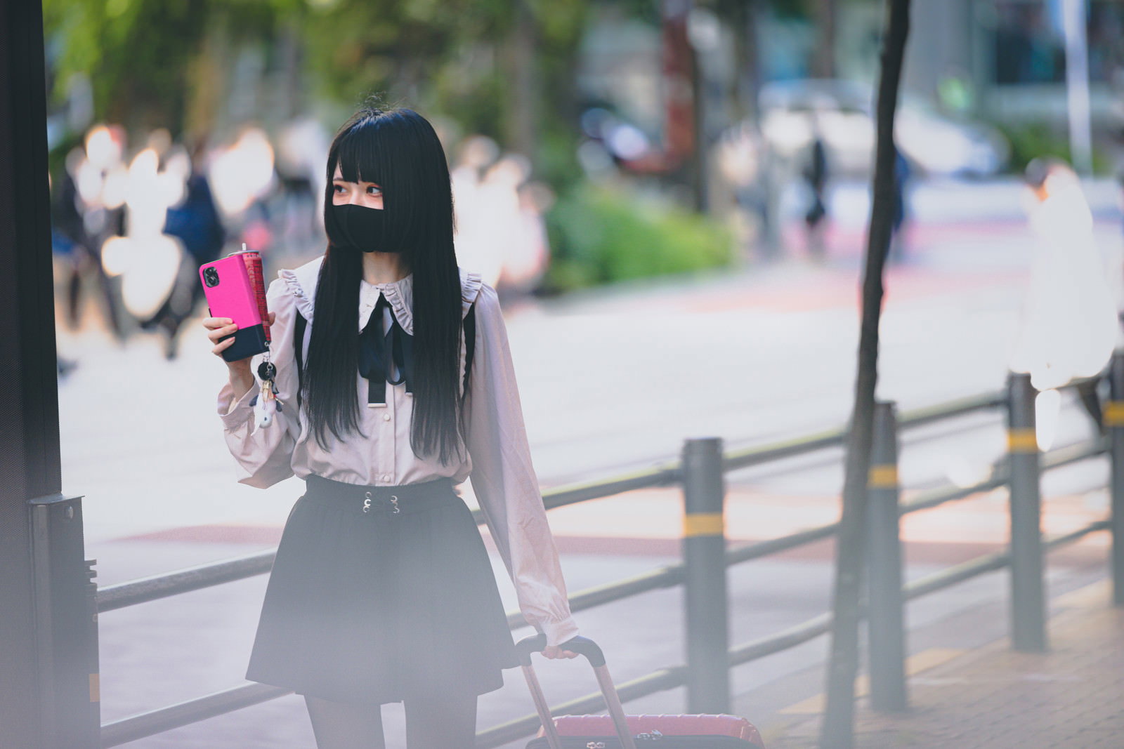 キャリーケースを引きずりながら歩道を移動する地雷系女子［モデル：緋真煉］