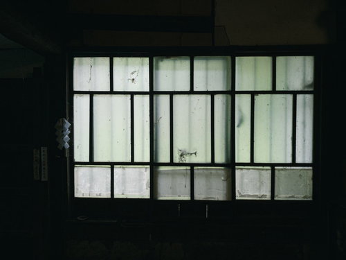 古民家の古い引き戸、薄暗い室内から見える汚れの目立つガラス窓