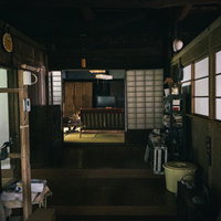 暗くて段差注意な古民家の廊下と和風建具・蛇口の写真