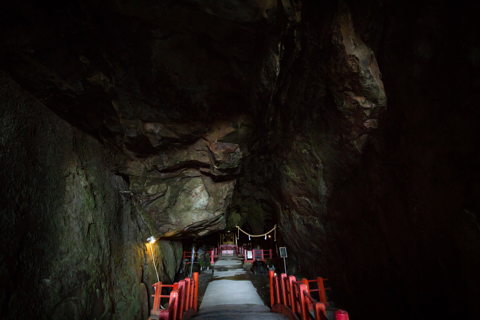 A mystical scene of the vermilion torii gates of the Gion Shrine within a cave