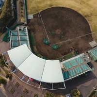 天福球場のバックネット裏観客席を上空から捉えた空撮の写真