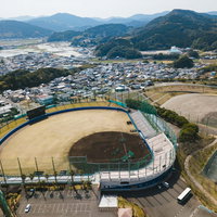 宮崎県日南市の南郷スタジアムと周辺町並みの空撮の写真