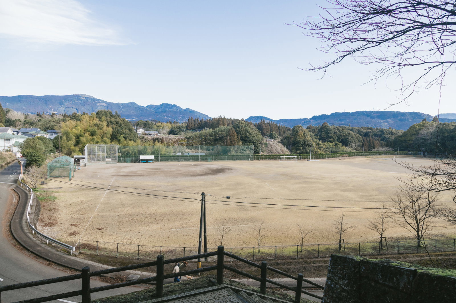 飫肥中学校の校庭を撮影した写真。広いグランドと山々の風景