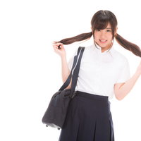 ちょっぴり照れる女子高生のメガホン応援の写真