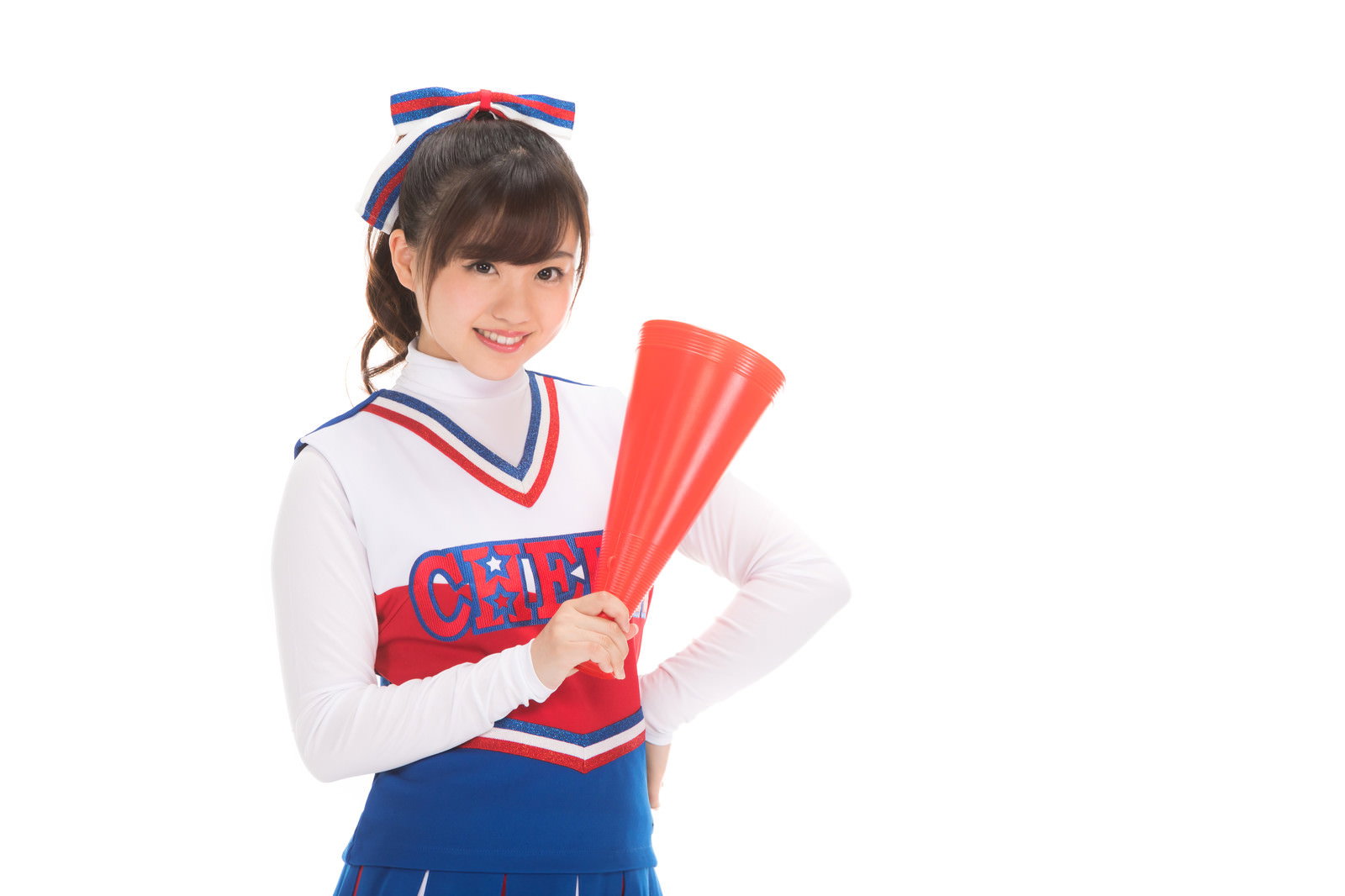 A cheerleader in a red and white uniform holding a megaphone while cheering