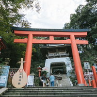 江島神社の参道入口に立つ朱色の大鳥居と石階段の写真