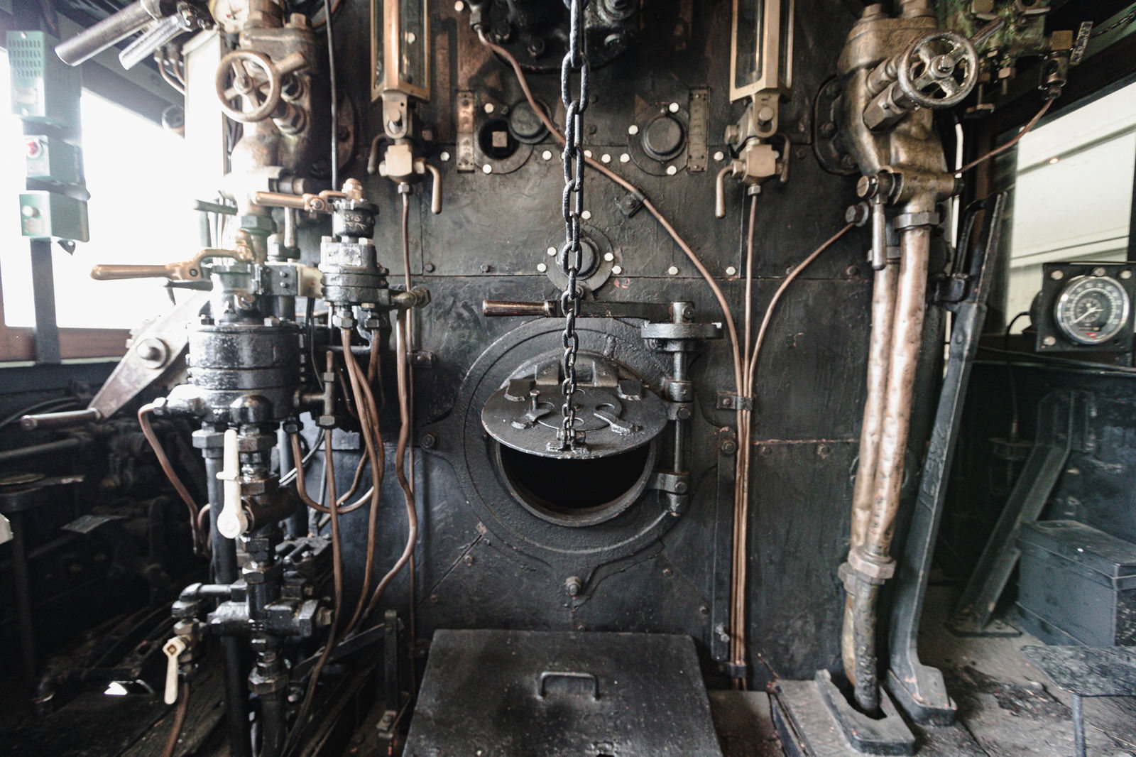 Various gauges and levers inside the cab of a steam locomotive