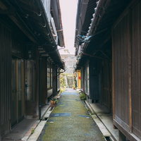 直方市の桜町小路に立ち並ぶ木造の長屋と石畳の路地の写真