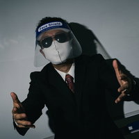 フェイスシールドにマスクとサングラス姿でプレゼンする会社員の写真