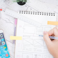 Webサイトをデザイン中、ノートにワイヤーフレームを手描きの写真