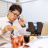 忙しいビジネスマンの夜食タイム、オフィスでピザとコーラで気分転換の写真