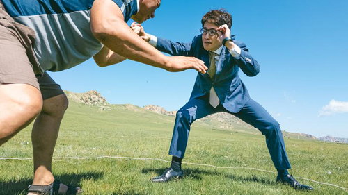 青空の草原で対峙するスーツ姿のビジネスマンと挑戦者