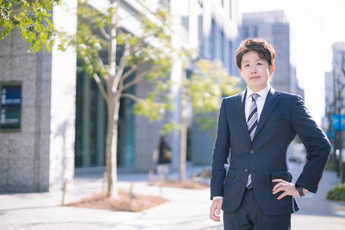 都市の街並みでポーズを取るM&Aアドバイザー