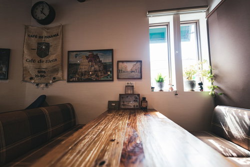 陽の光が差し込むカフェの木製テーブルの温かみのある空間