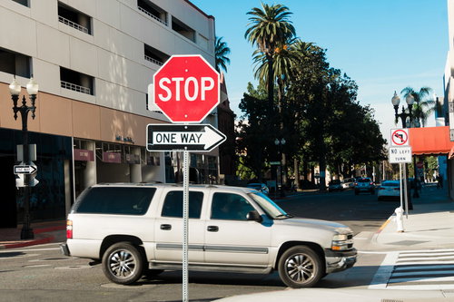 アメリカの道路に立つSTOP ONE WAY標識