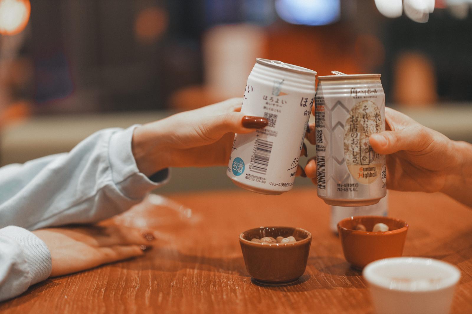 眼鏡をかけた男性が両手を握り、怪しい笑顔で何かを隠している表情